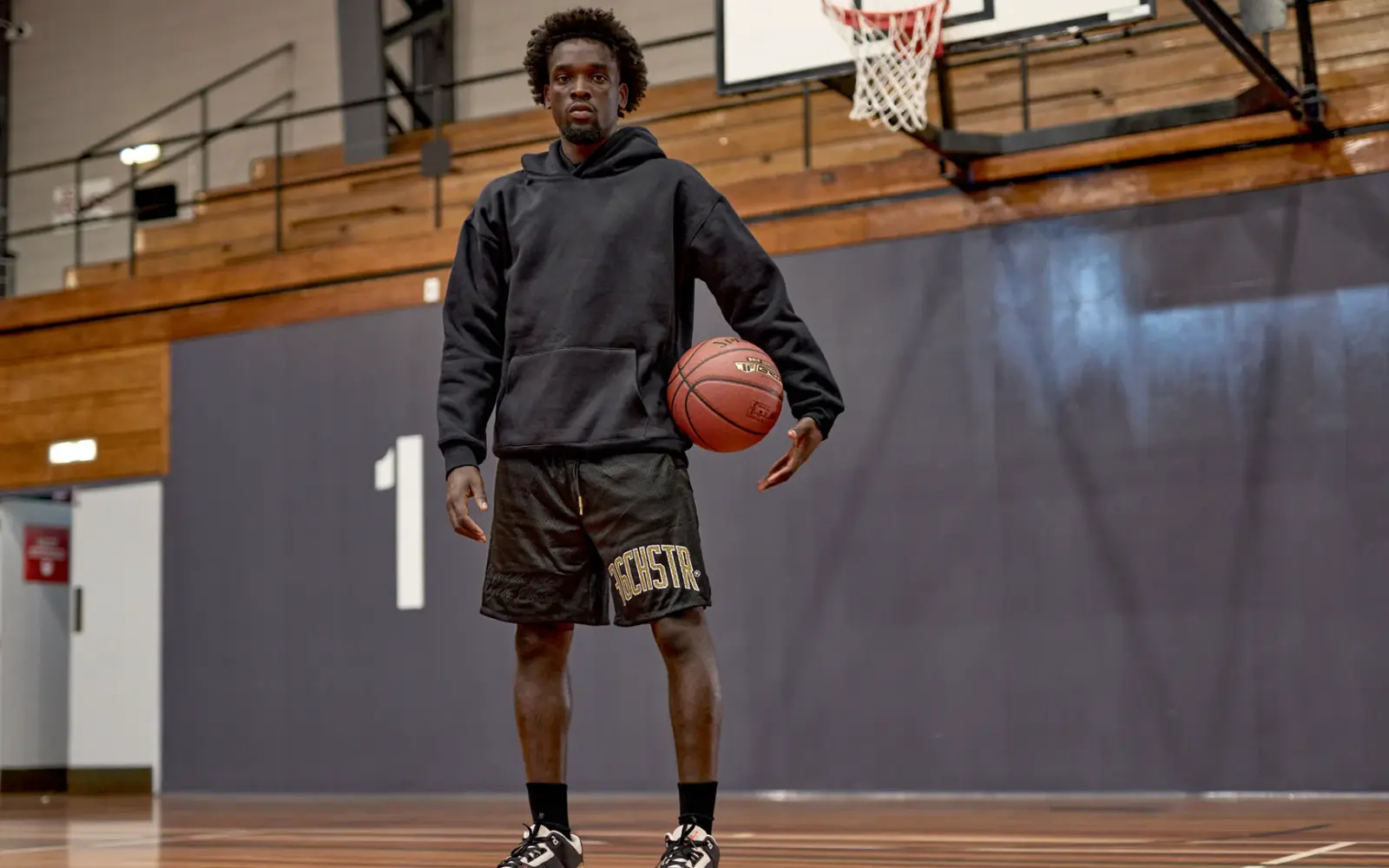 36Chester apparel — athlete holding a basketball on an indoor court